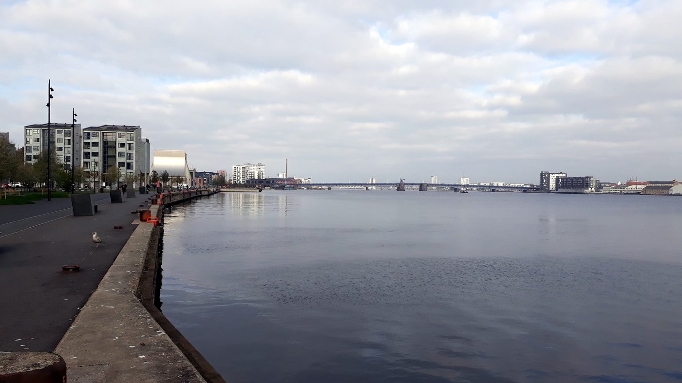 Aalborg waterfront at golden hour with the Utzon Center and Limfjord promenade