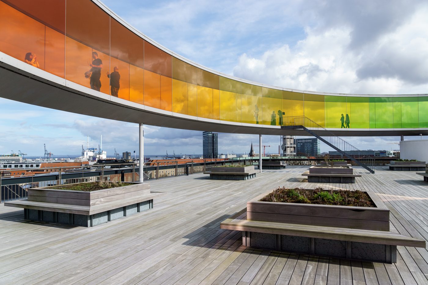 ARoS Aarhus Kunstmuseum with the rainbow walkway on the rooftop, glowing against the city skyline