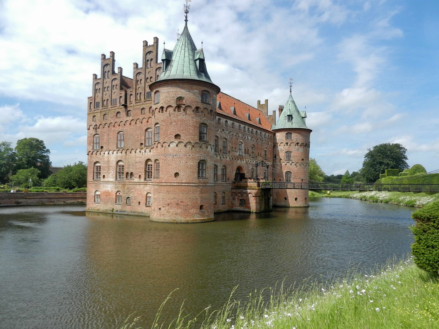Egeskov Castle on Funen — renaissance moated castle reflected in its lake