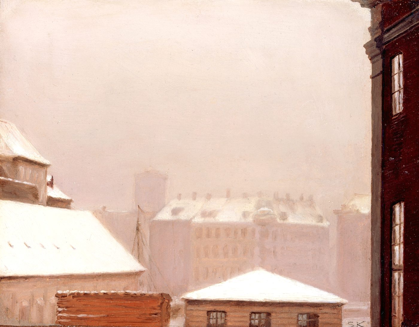 Copenhagen rooftops blanketed in snow under a low winter sky